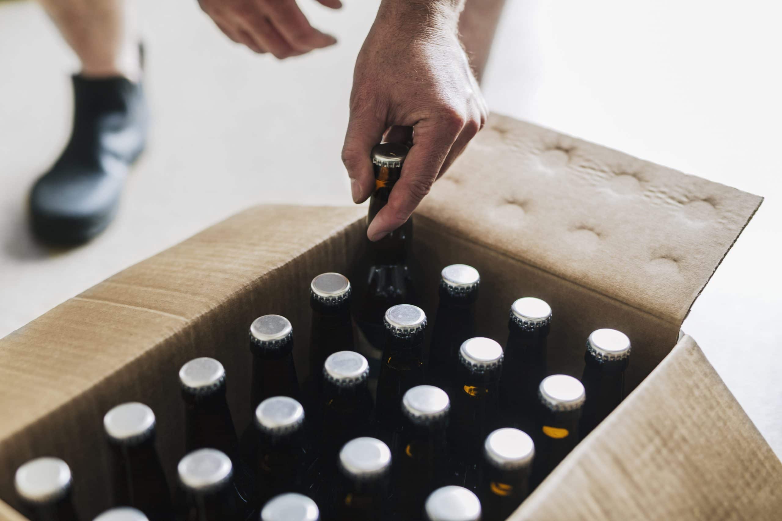 /beer-packaging/brewery-worker-putting-beer-bottles-into-cardboard.jpg