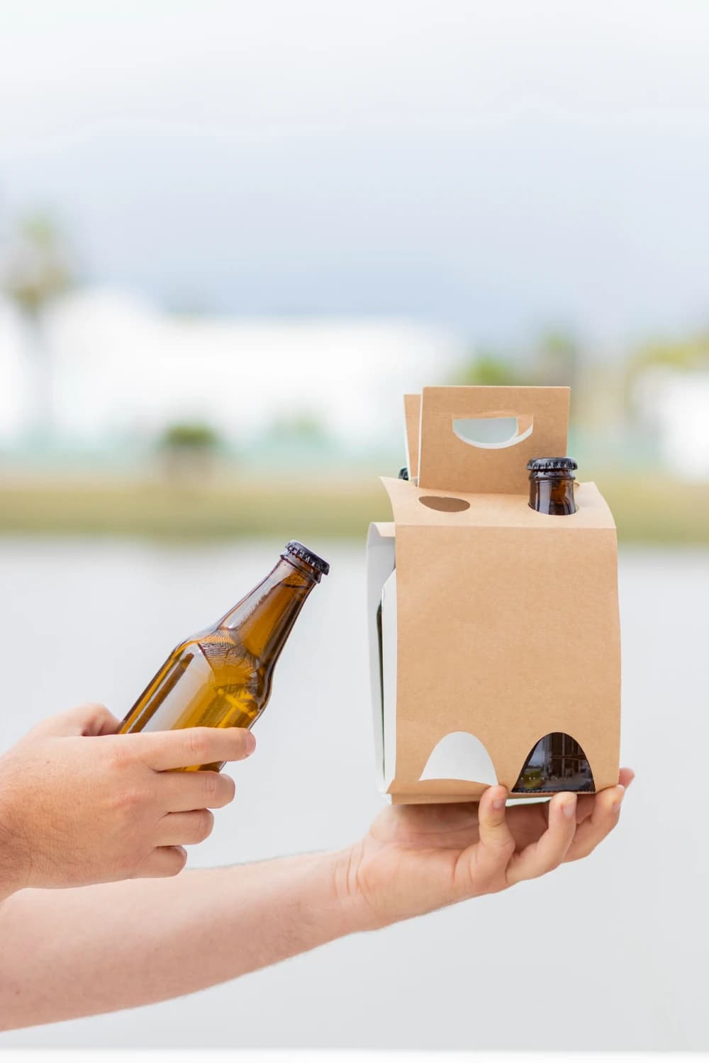 Holding 4-bottle pack of beer